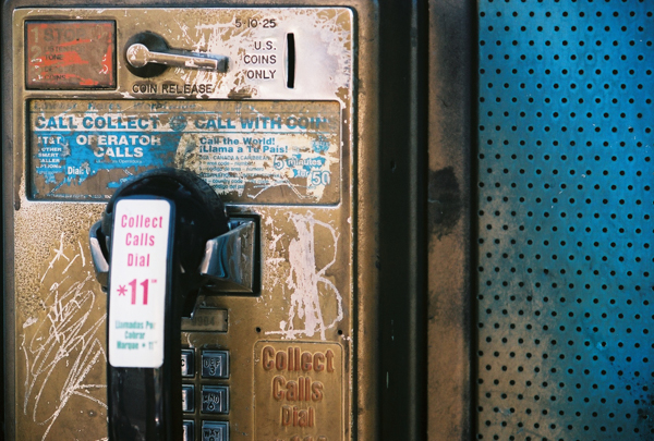 Series Title: Abstracts of the Broken and Used.</br></br> Series Info: I am fasinated with objects that have been thrown away or left to rot. I often find stories, personality traits, and feelings in each unquie setting. </br></br> Image Title: Calling Long Distance </br> </br>Details: A payphone outside of a bar covered in dirt and grime.