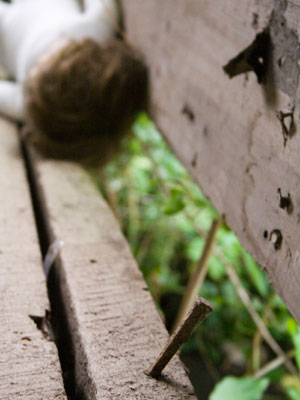 Series Title: Abstracts of the Broken and Used.</br></br> Series Info: I am fasinated with objects that have been thrown away or left to rot. I often find stories, personality traits, and feelings in each unquie setting. </br></br> Image Title: Nail </br> </br>Details: A rusty nail sticking out of a floorboard of a decrepit house.